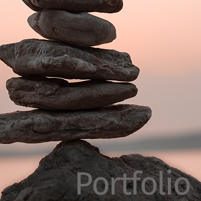 picture of flat rocks stacked on top of each other in front of a sunset